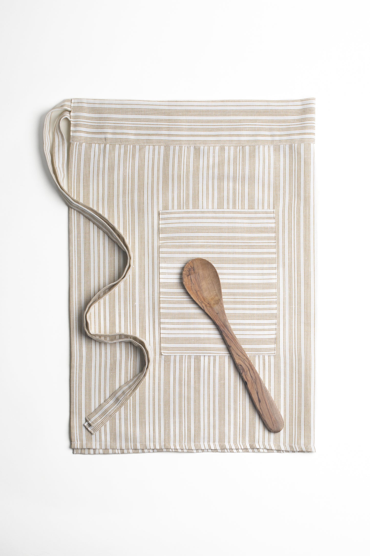 This Garden Half Apron by Bonnie Christine, made from breathable cotton-linen in a goldenrod stripe, features a flattering wrap-around fit, two roomy front pockets, and a soft, lived-in feel, perfect for baking, gardening, or creative work.