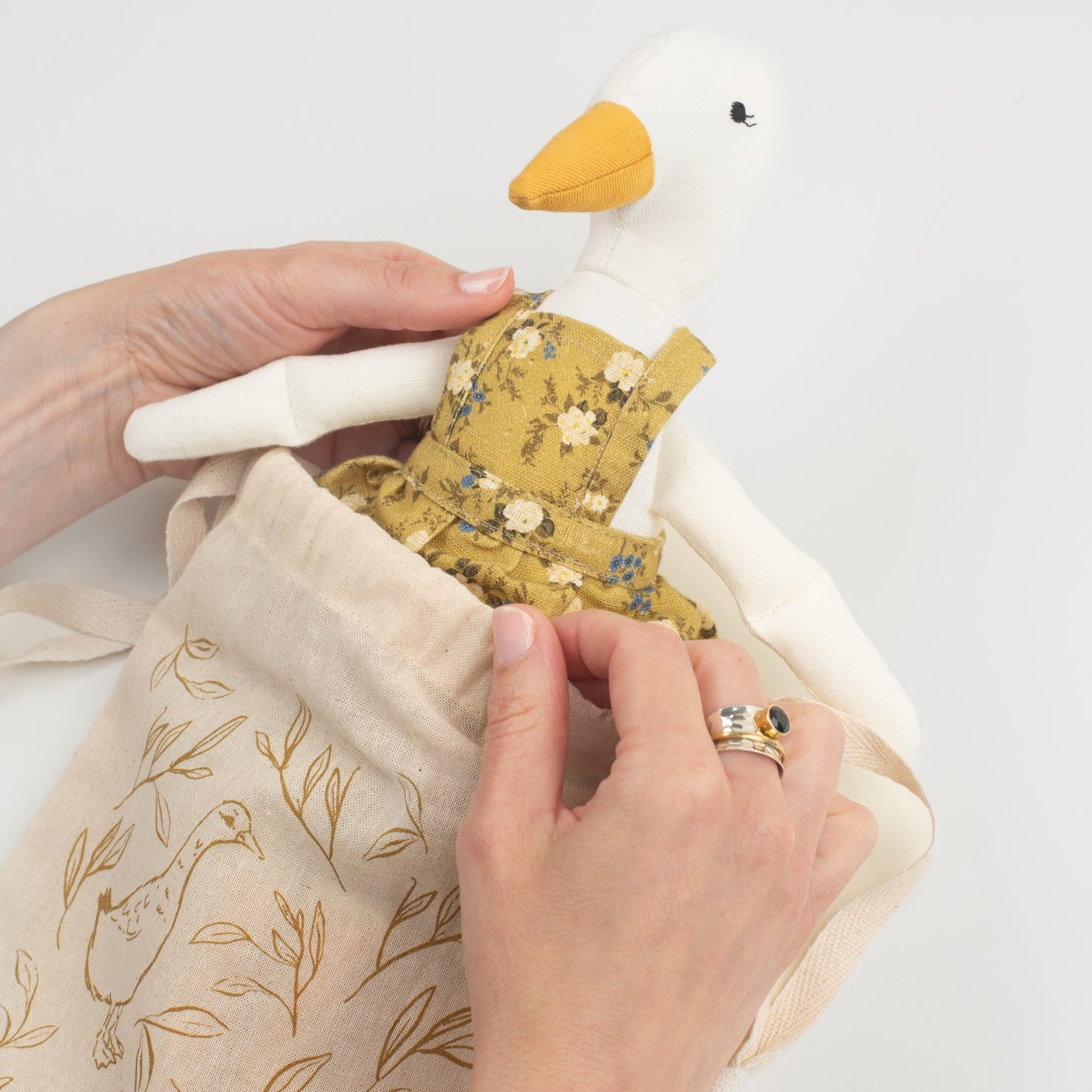 Meet Birdie, the softie duck doll by Bonnie Christine, dressed in a breezy floral linen dress and handcrafted from soft cotton, perfect for children’s playtime, snuggles, or adding a whimsical charm to any child’s space or nursery shelf decor.