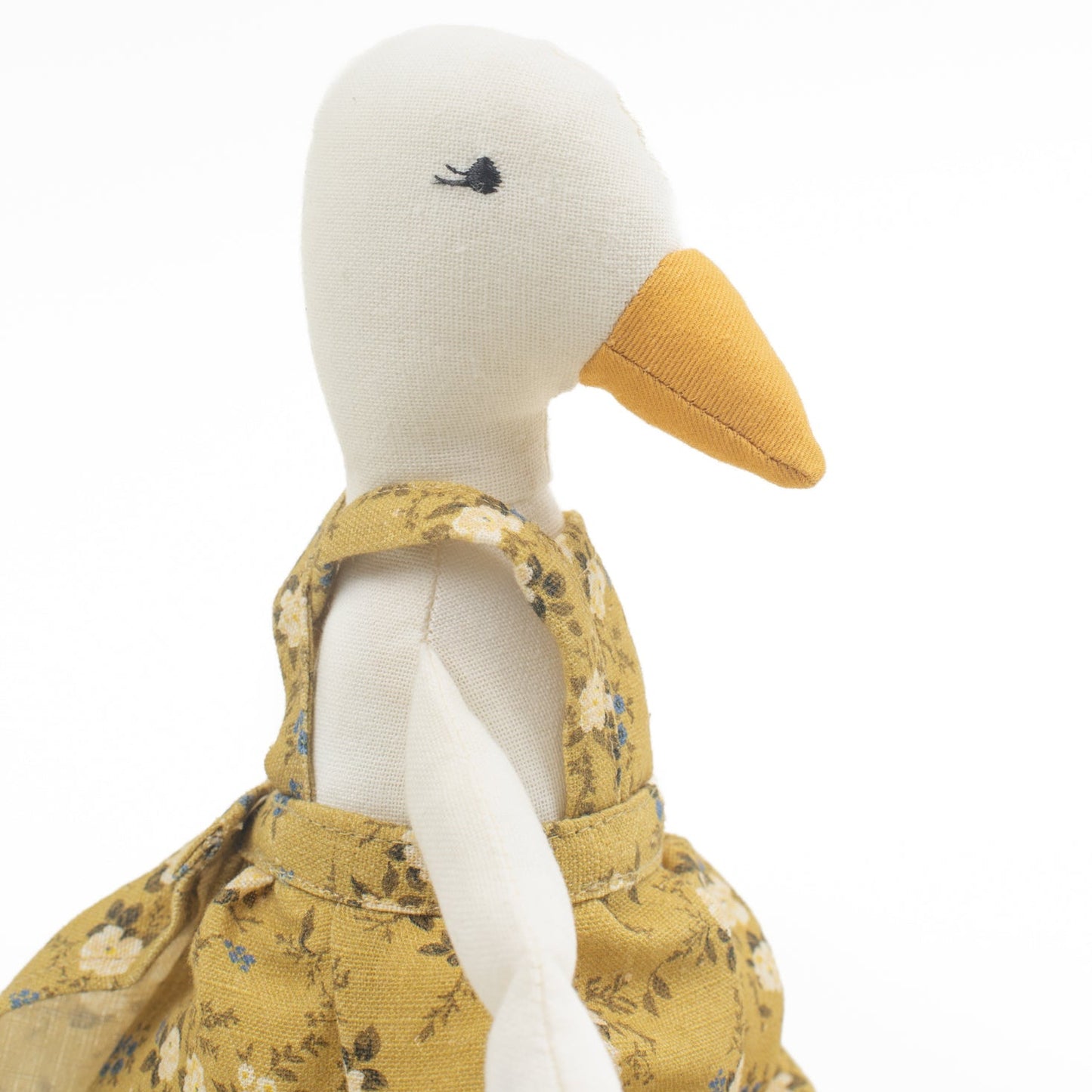 Meet Birdie, the softie duck doll by Bonnie Christine, dressed in a breezy floral linen dress and handcrafted from soft cotton, perfect for children’s playtime, snuggles, or adding a whimsical charm to any child’s space or nursery shelf decor.