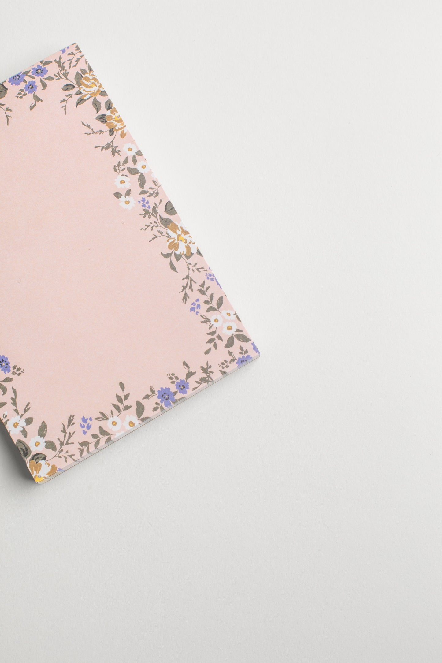 This Blossom Small Notepad by Bonnie Christine features soft floral designs on each of its 75 tear-off pages, perfect for capturing quick notes, to-dos, or bursts of inspiration in a petite, portable format.