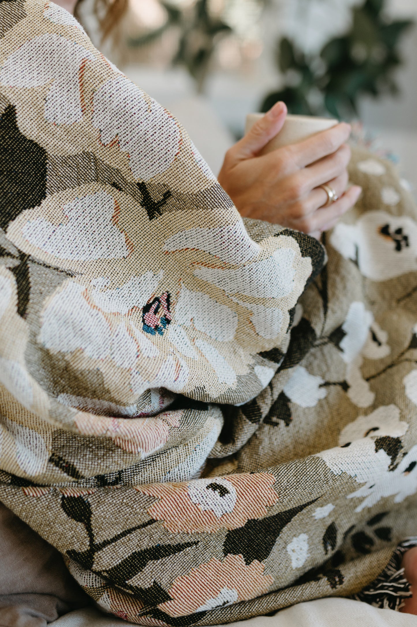This Cocoon Throw Blanket by Bonnie Christine, woven from 100% Carolina-grown cotton in a floral jacquard tapestry, brings a touch of cottage-core charm to cozy home moments, perfect for gifting, layering, or a garden picnic.