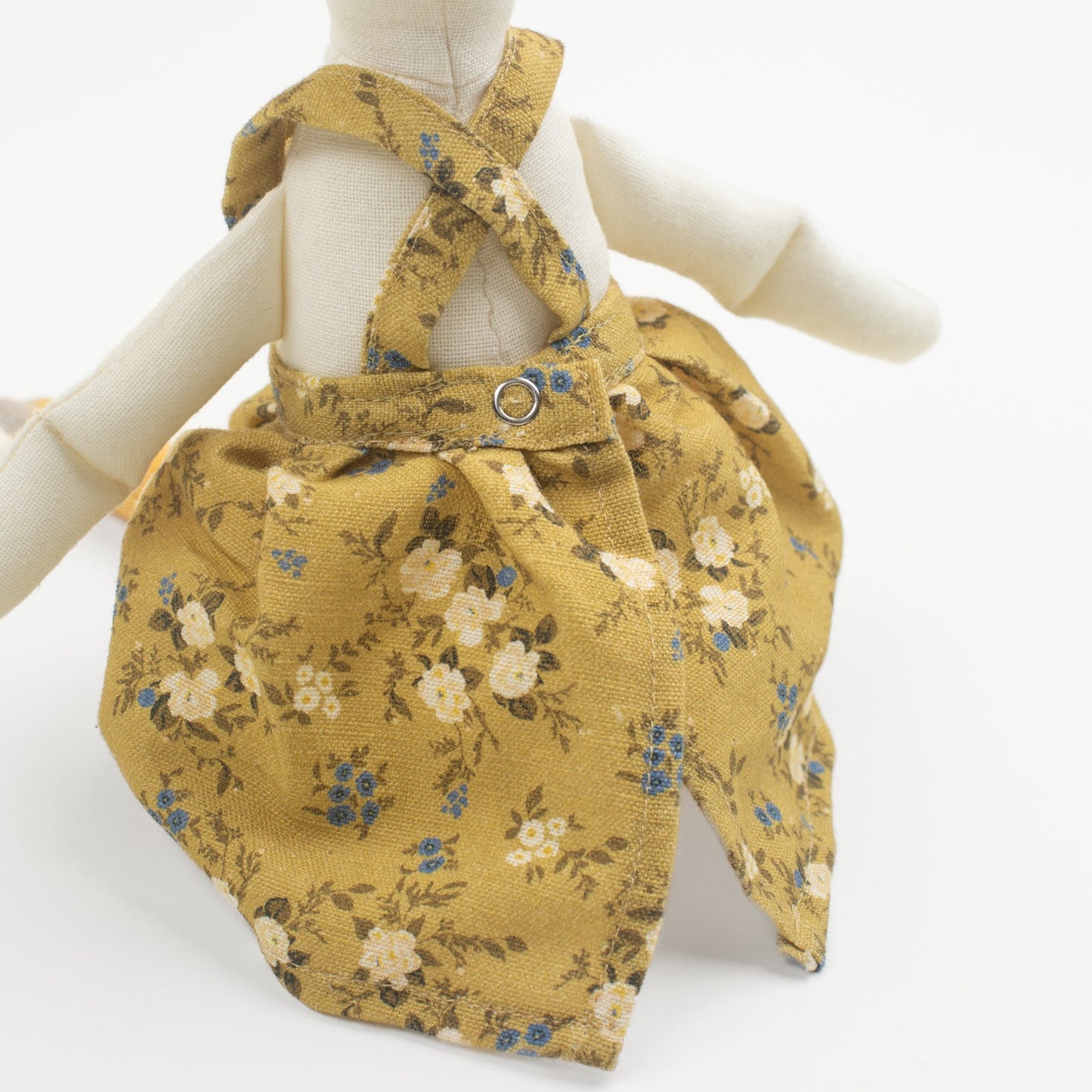 Meet Birdie, the softie duck doll by Bonnie Christine, dressed in a breezy floral linen dress and handcrafted from soft cotton, perfect for children’s playtime, snuggles, or adding a whimsical charm to any child’s space or nursery shelf decor.