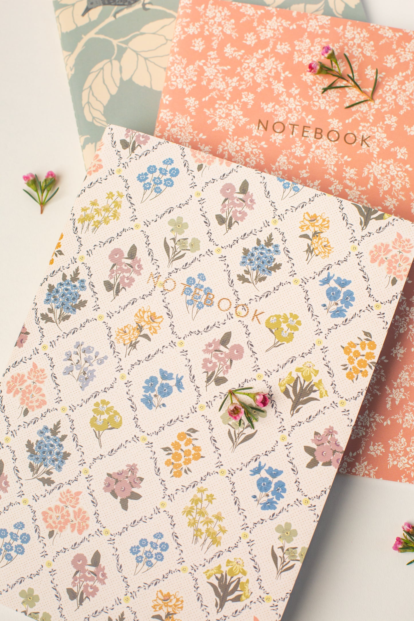 This Reverie Notebook Set by Bonnie Christine includes three softcover journals with delicate floral designs and gold foil accents, perfect for journaling, everyday note-taking, gifting, or brightening a creative workspace.