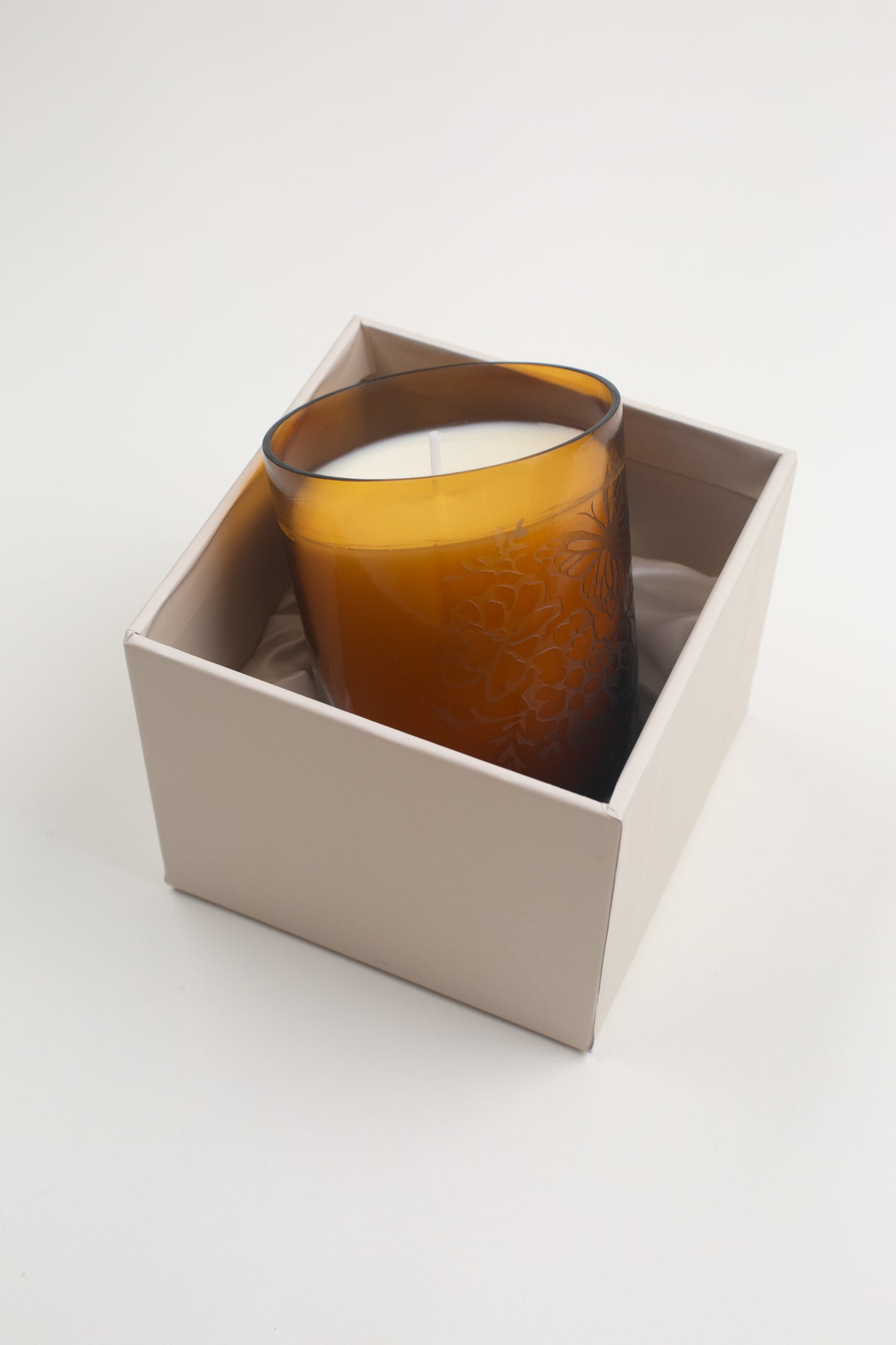 This Meadow Signature Candle by Bonnie Christine, with its etched floral amber glass vessel and handmade box, adds a warm, inviting touch to home decor, making it the perfect gift or housewarming present for those who love cozy, artful spaces.