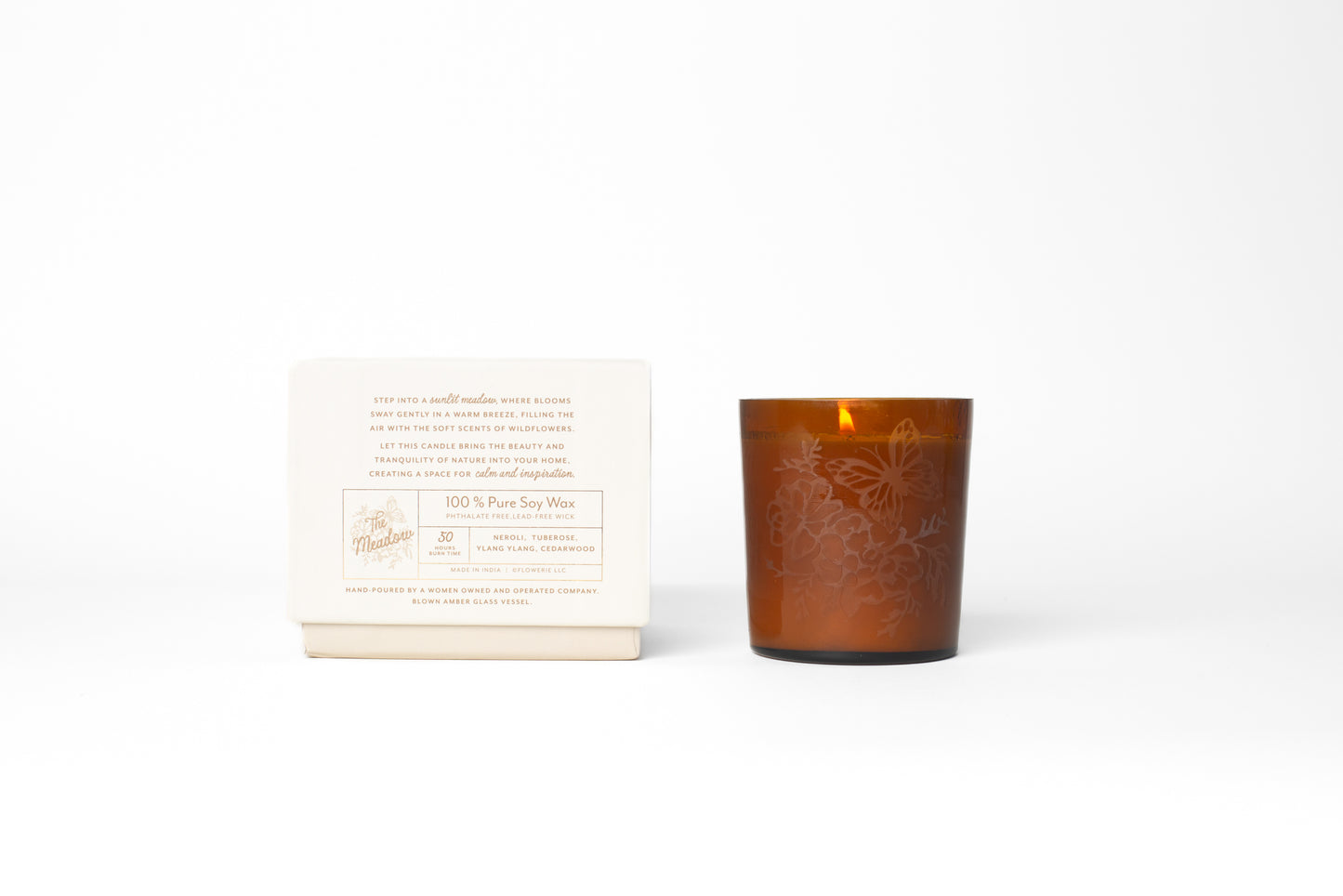 This Meadow Signature Candle by Bonnie Christine, with its etched floral amber glass vessel and handmade box, adds a warm, inviting touch to home decor, making it the perfect gift or housewarming present for those who love cozy, artful spaces.