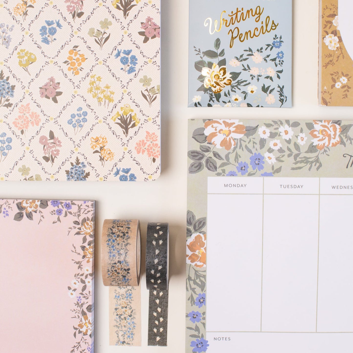 This stationery collection by Bonnie Christine includes the Blossom Small Notepad, Blossom Large Notepad, Blossom Weekly Planner Notepad, Blossom List, Pipet Pencil Set, Reverie Notebook Trio Set, and Masking Tape-washi tape all adorned with delicate floral designs, perfect for adding beauty to everyday planning, note-taking, and list-making.
