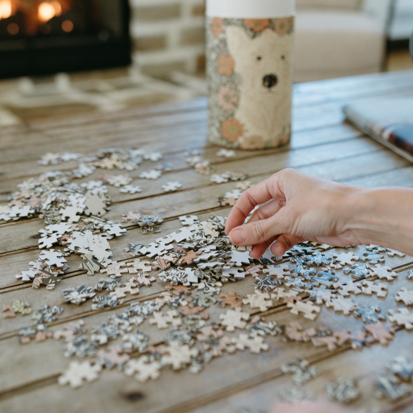 This Woodland Dreams Puzzle by Bonnie Christine features a friendly bear and wildflowers in a charming design, with 1000 pieces packaged in a rigid tube box, perfect for gifting or enjoying quiet cottage-core afternoons.