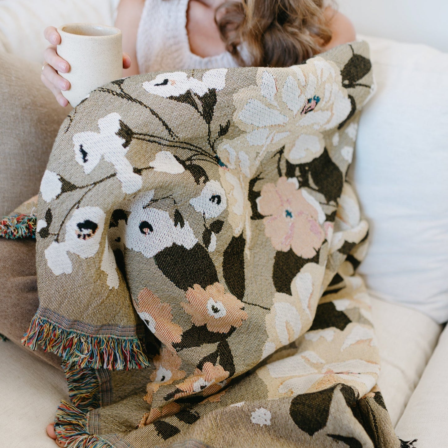 This Cocoon Throw Blanket by Bonnie Christine, woven from 100% Carolina-grown cotton in a floral jacquard tapestry, brings a touch of cottage-core charm to cozy home moments, perfect for gifting, layering, or a garden picnic.