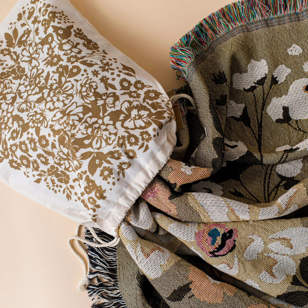 
                  
                    This Cocoon Throw Blanket by Bonnie Christine, woven from 100% Carolina-grown cotton in a floral jacquard tapestry, brings a touch of cottage-core charm to cozy home moments, perfect for gifting, layering, or a garden picnic.
                  
                