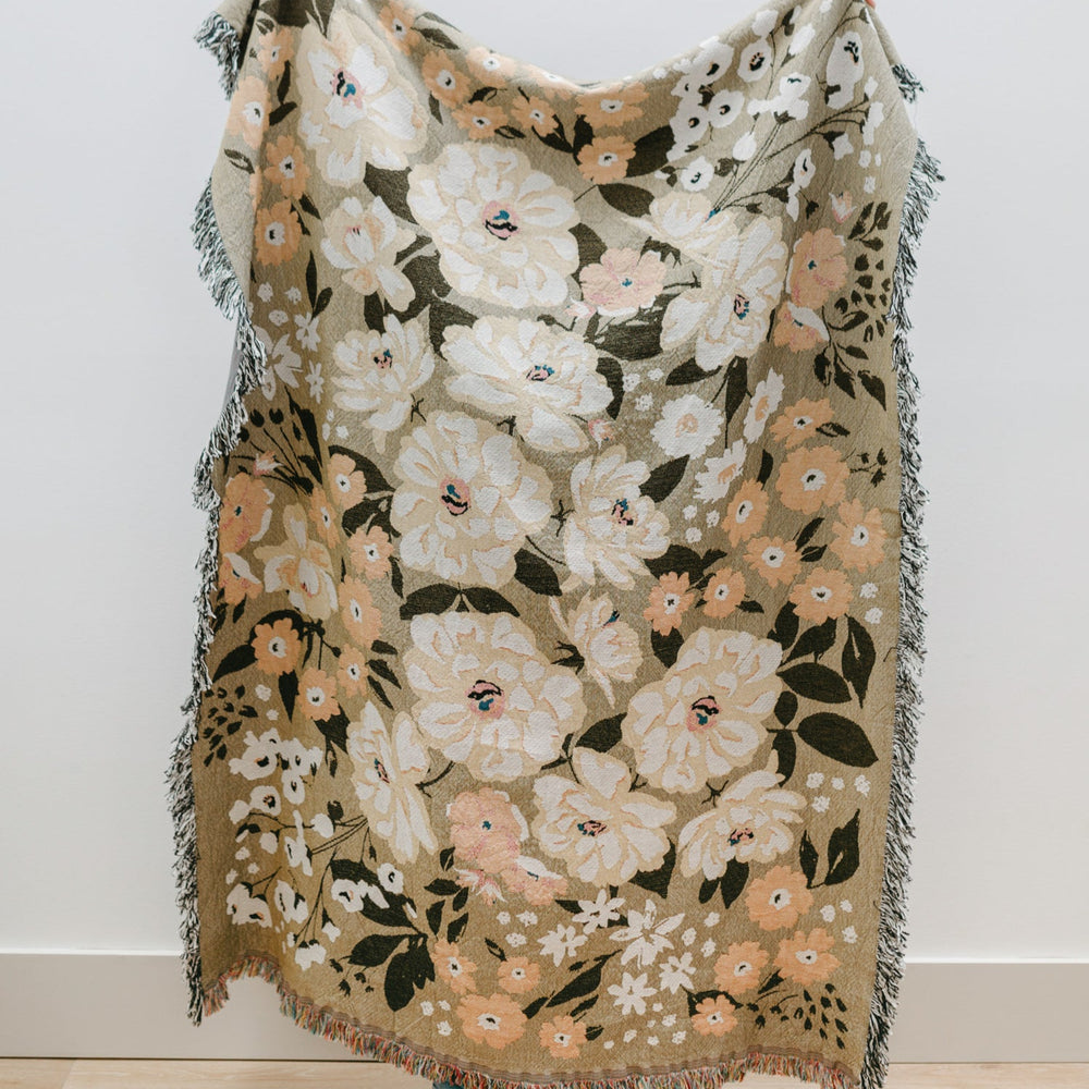 
                  
                    This Cocoon Throw Blanket by Bonnie Christine, woven from 100% Carolina-grown cotton in a floral jacquard tapestry, brings a touch of cottage-core charm to cozy home moments, perfect for gifting, layering, or a garden picnic.
                  
                