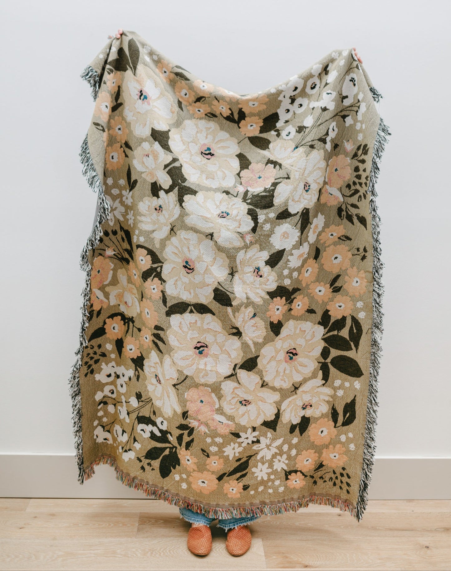 This Cocoon Throw Blanket by Bonnie Christine, woven from 100% Carolina-grown cotton in a floral jacquard tapestry, brings a touch of cottage-core charm to cozy home moments, perfect for gifting, layering, or a garden picnic.