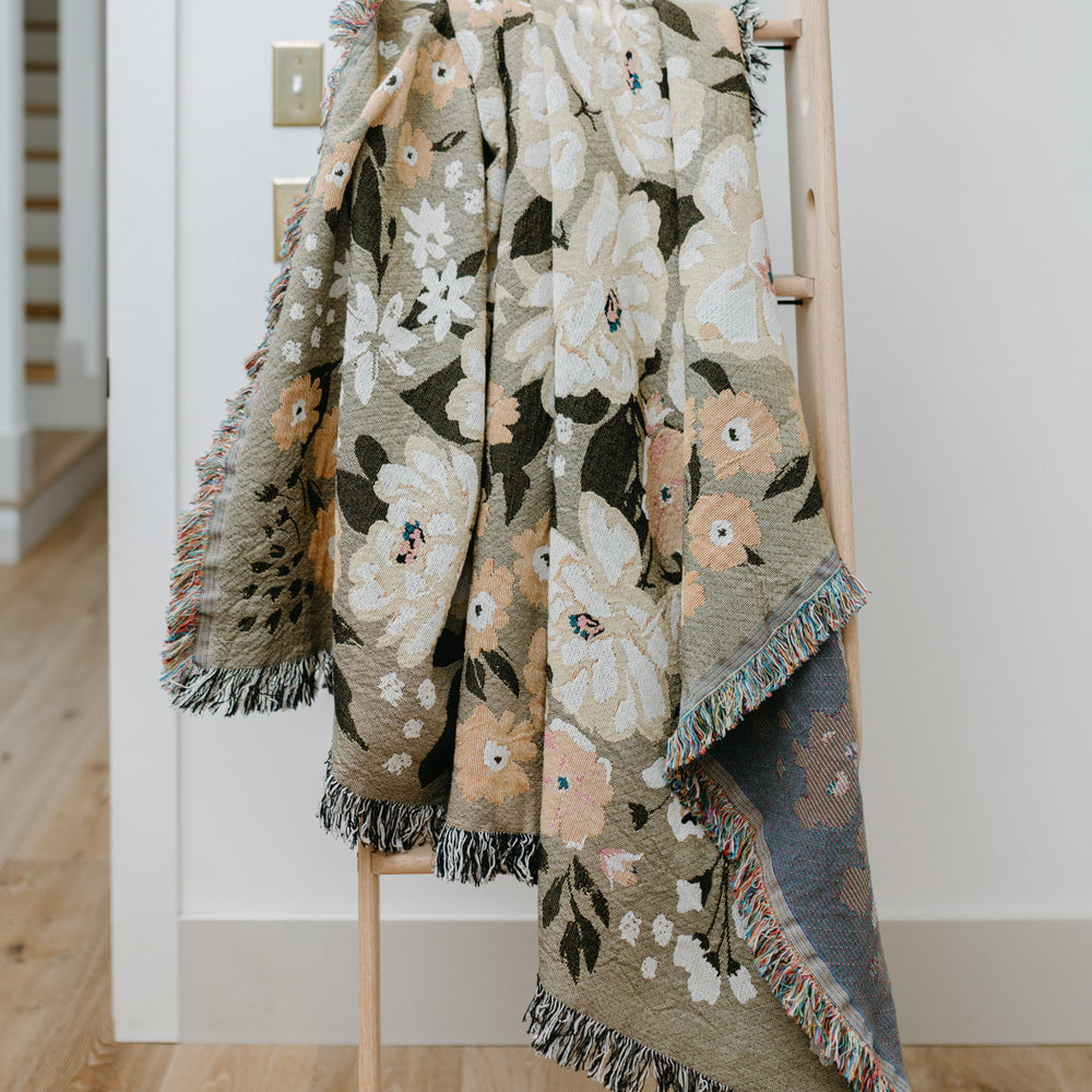 
                  
                    This Cocoon Throw Blanket by Bonnie Christine, woven from 100% Carolina-grown cotton in a floral jacquard tapestry, brings a touch of cottage-core charm to cozy home moments, perfect for gifting, layering, or a garden picnic.
                  
                