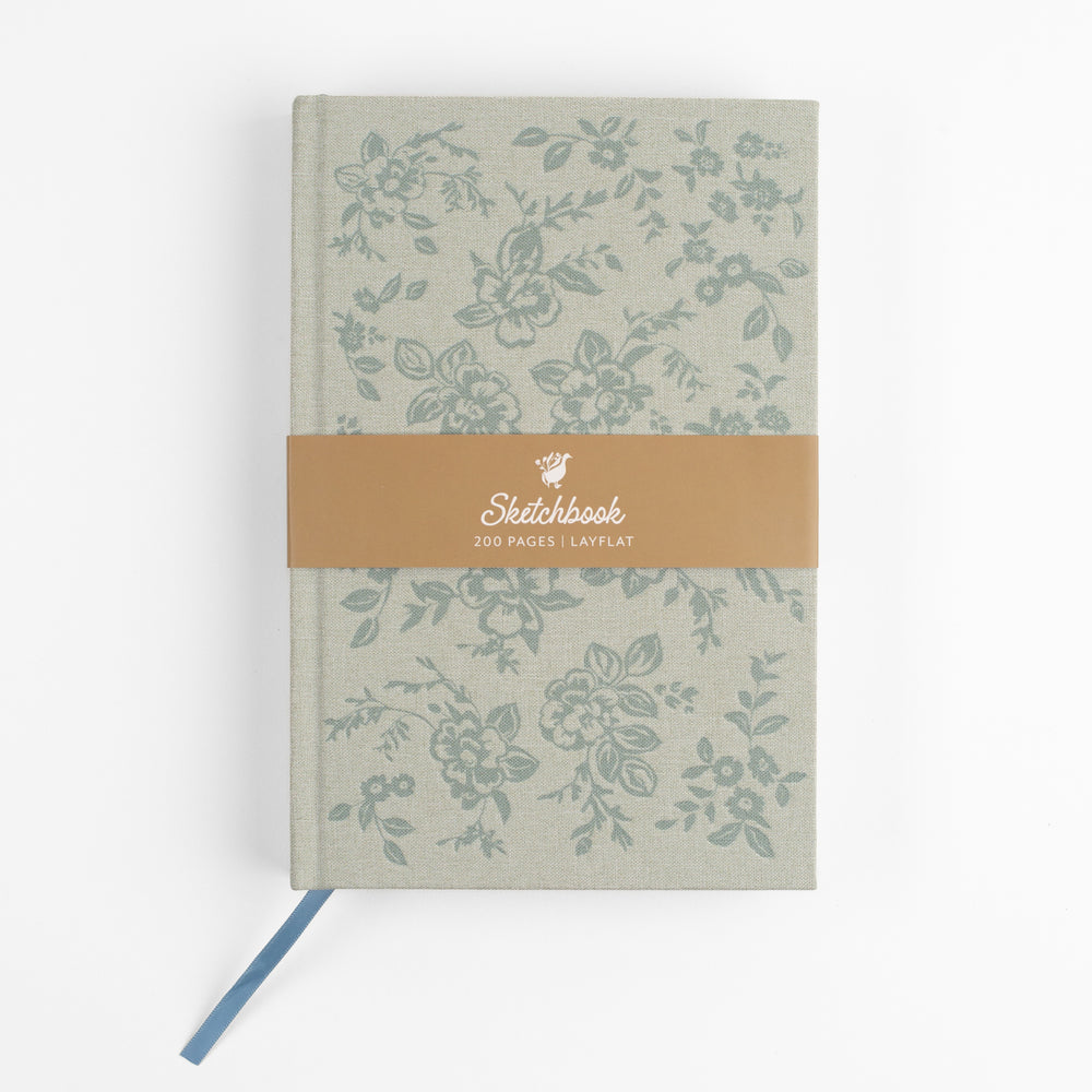 Surface Pattern Designer and Creative Entrepreneur Bonnie Christine introduces the Daydreamer Sketchbook, exclusively designed for Flowerie Shop, featuring a textured linen cover, gold foil spine, and debossed design.